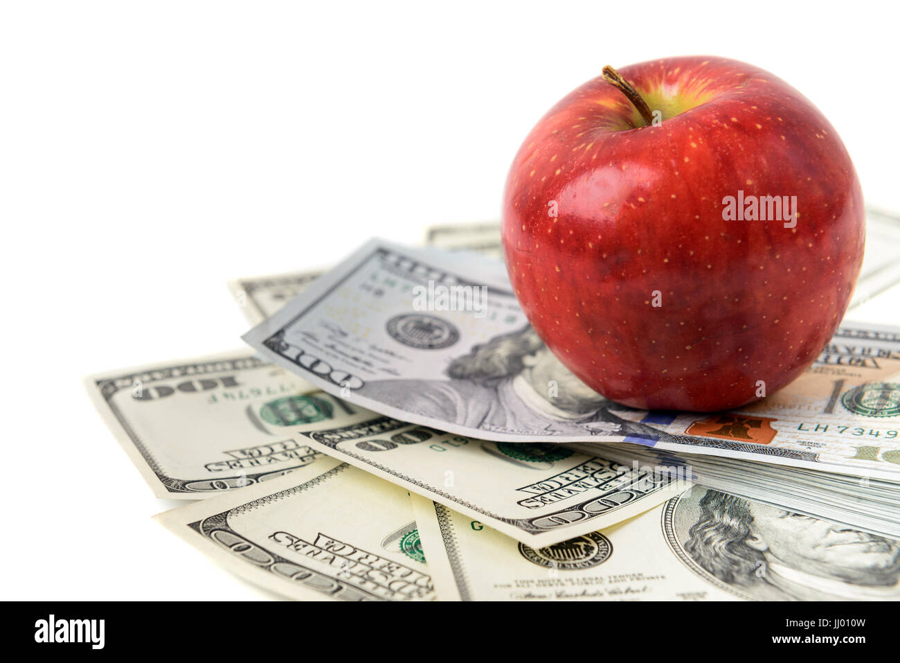 Dollars with red apple isolated on white Stock Photo