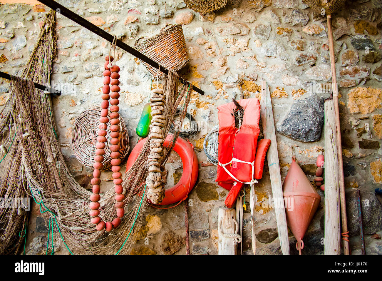 Old ancient fishing nets and tackes on the brick wall, small fisherman  village Avola, Sicily, Italy Stock Photo - Alamy