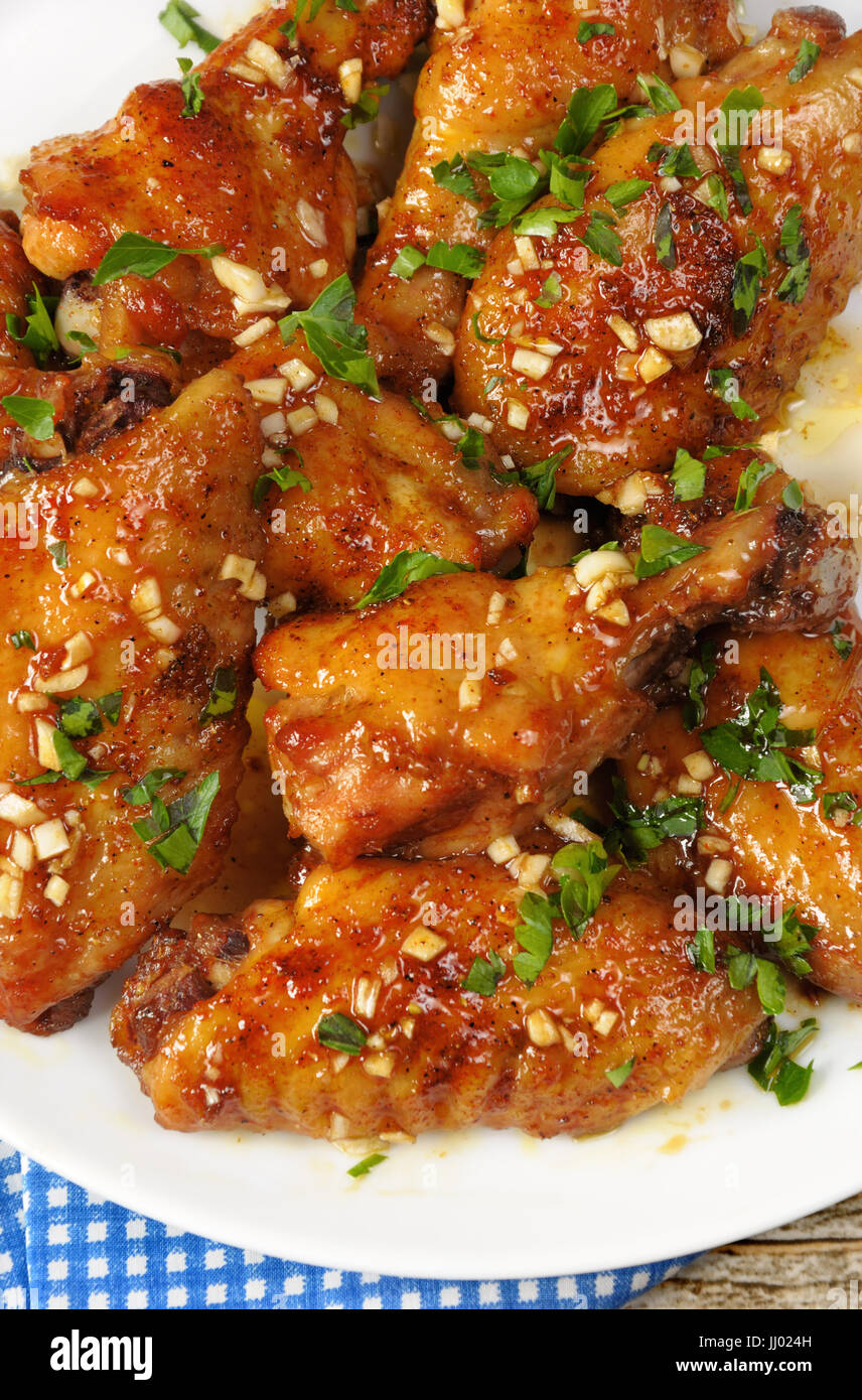 Fried chicken wings in ginger garlic marinade with herbs Stock Photo