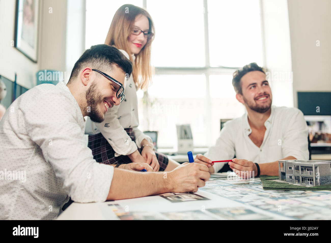 Confident team of engineers working together in a architect studio Stock Photo