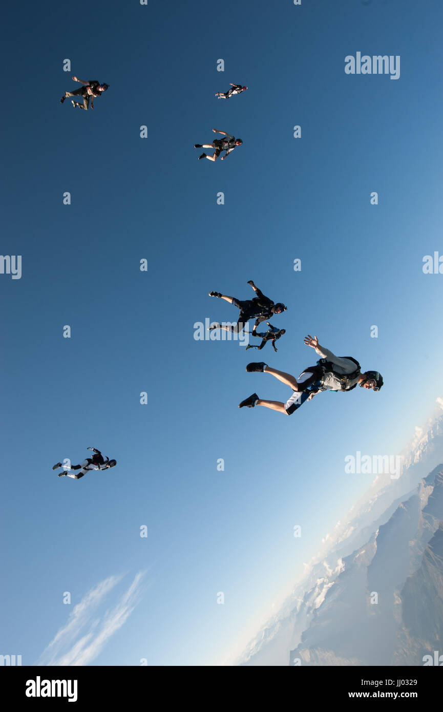 Skydivers follow eachother on a tracking skydive above Locarno, Switzerland Stock Photo