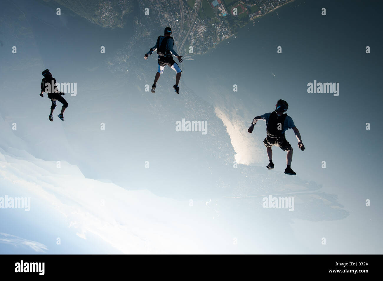 Skydivers tracking towards Lago Maggiore, Switzerland Stock Photo