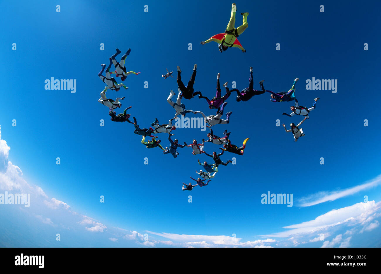 Skydivers tumble through the air after exiting an Mi26 helicopter Stock Photo