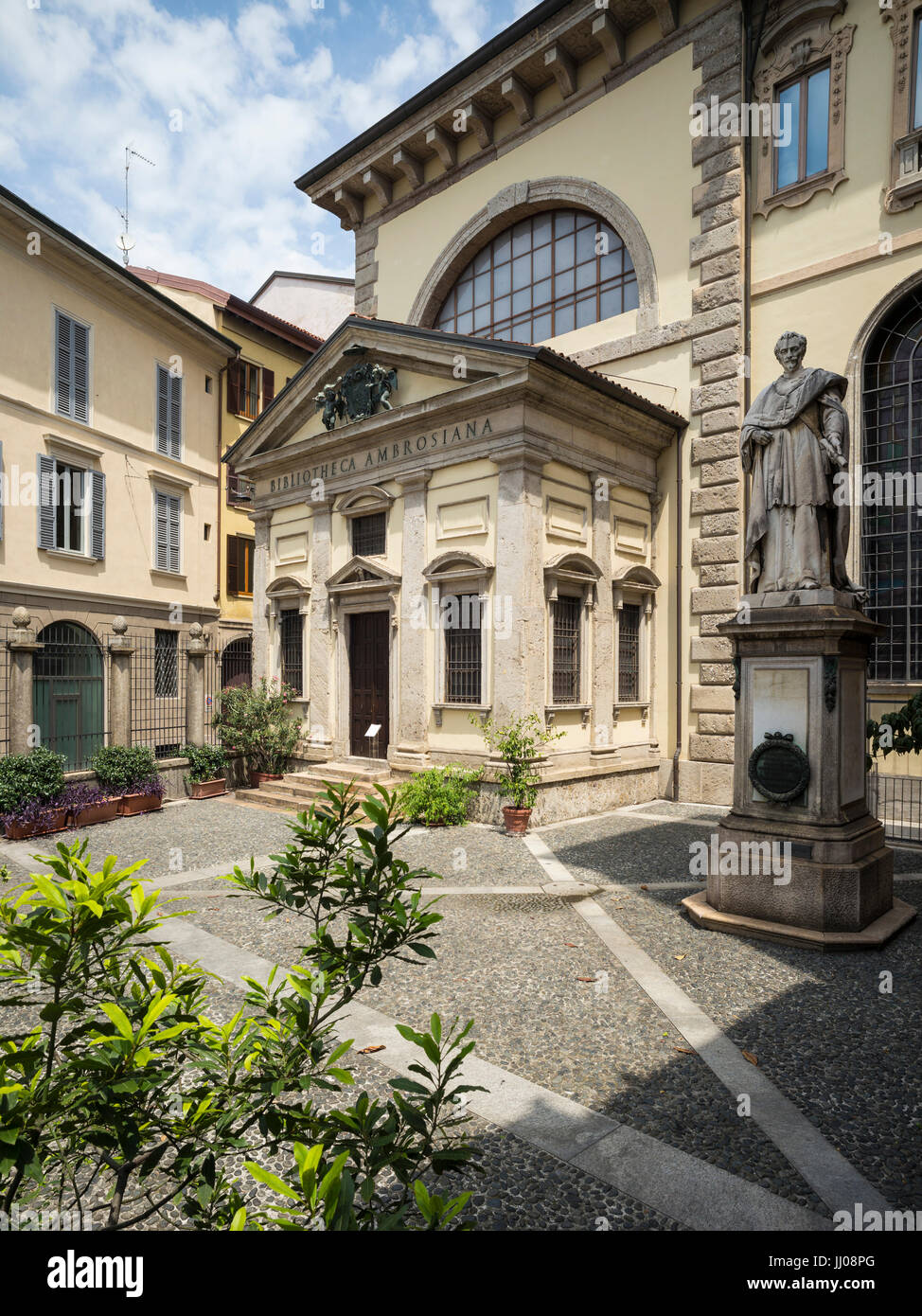 Milan. Italy. Original entrance to the Biblioteca Ambrosiana on Piazza San Sepolcro, opened 1609, and statue of Cardinal Federico Borromeo (1564–1631) Stock Photo