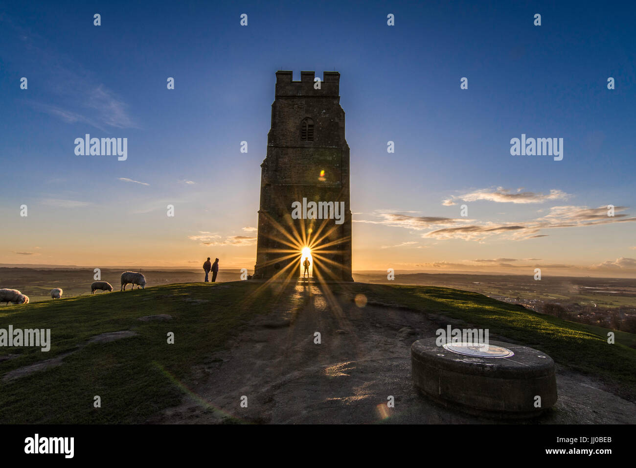 The sunset seen through the archway on Glastonbury Tor, Somerset ...