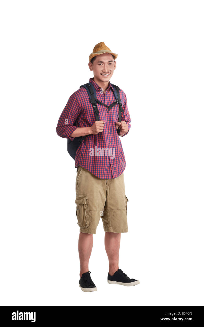 Happy asian traveler wearing hat with backpack standing over white background Stock Photo