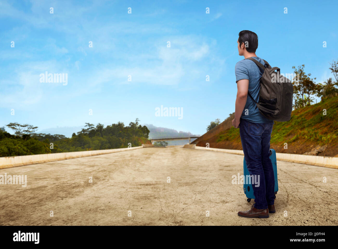 Portrait of asian traveler standing with suitcase enjoying panorama view Stock Photo