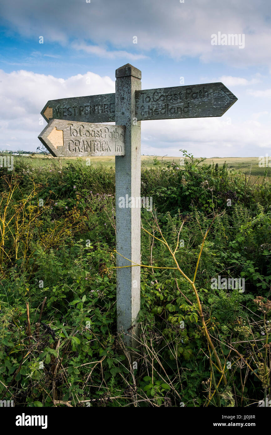 Sign Post On Path A wooden signpost on a footpath giving directions to West Pentire and ...