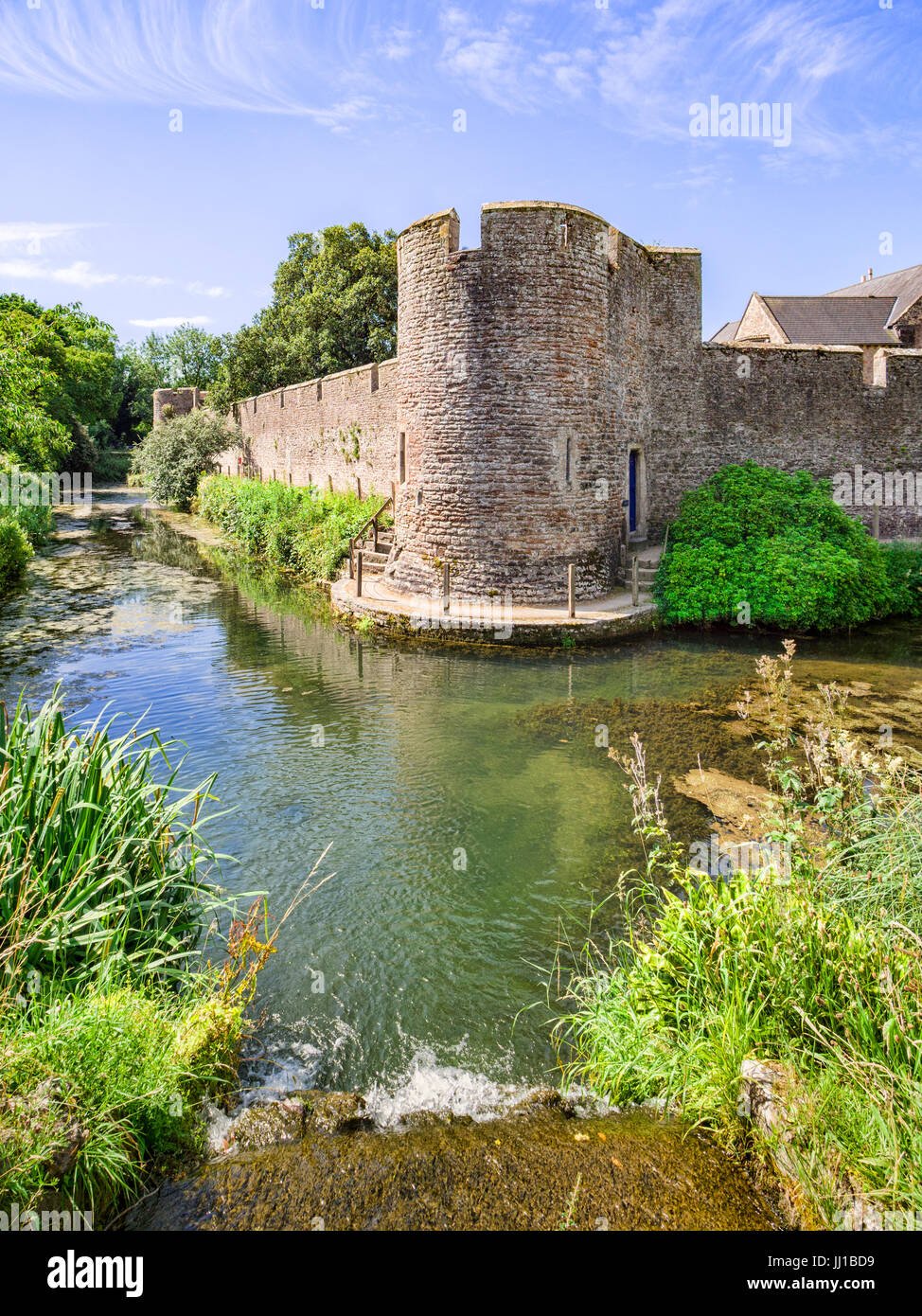 The moat and curtain wall surrounding the medieval Bishop's Palace at Wells, Somerset, England, UK. Stock Photo