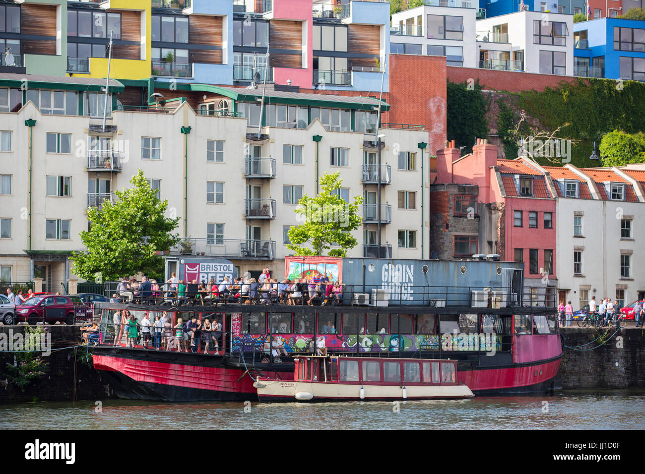 People drink on The Grain Barge - a pub and bar on a boat owned by Bristol Beer Factory - during Harbour Festival. Stock Photo