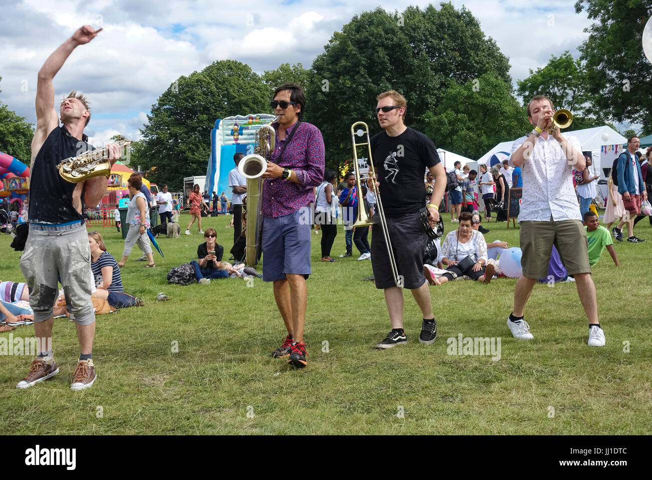 Brass band playing in festival field hires stock photography and