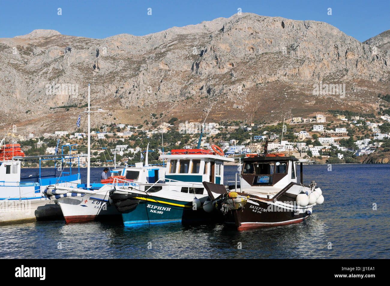 fishing boats in Telendos islet and Kalymnos in the background, Greece