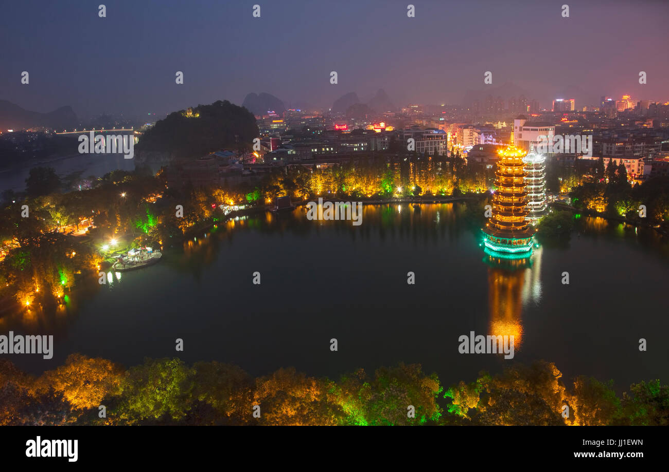 Evening view of the Gold and Silver Pagodas, also known as the Sun and Moon Pagodas, reflected in Shan Lake  Guilin, Guangxi Province, China. Stock Photo