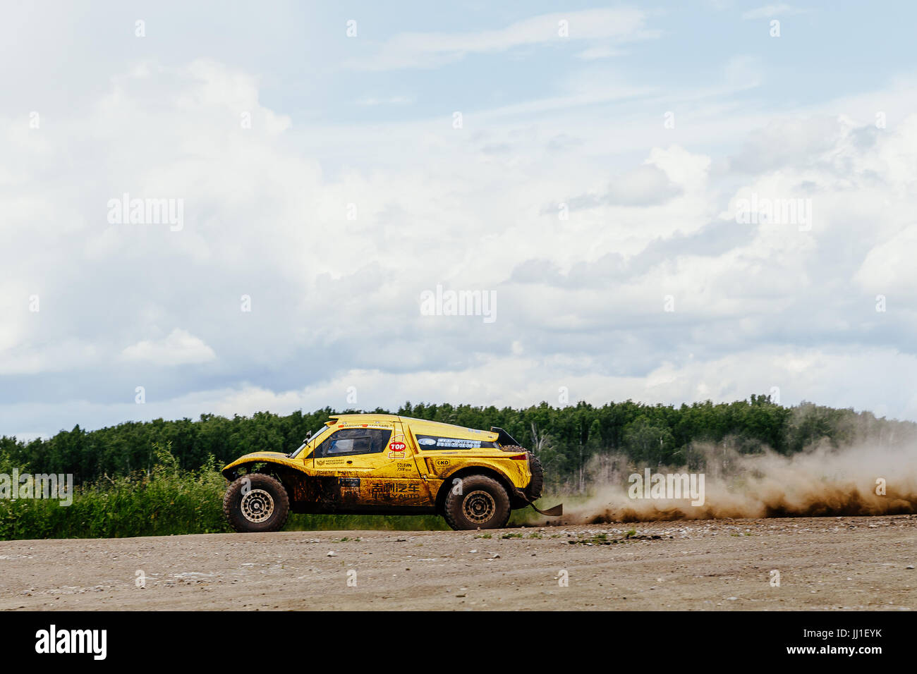 chinese riders on rally car driving on dust road during Silk way rally Stock Photo