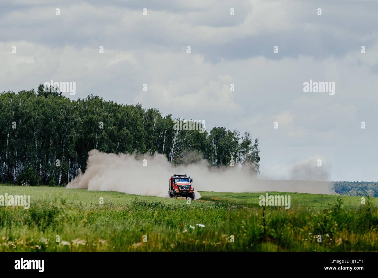 Dust Rally Road truck rally car Renault driving on dust road among forest and grass ...