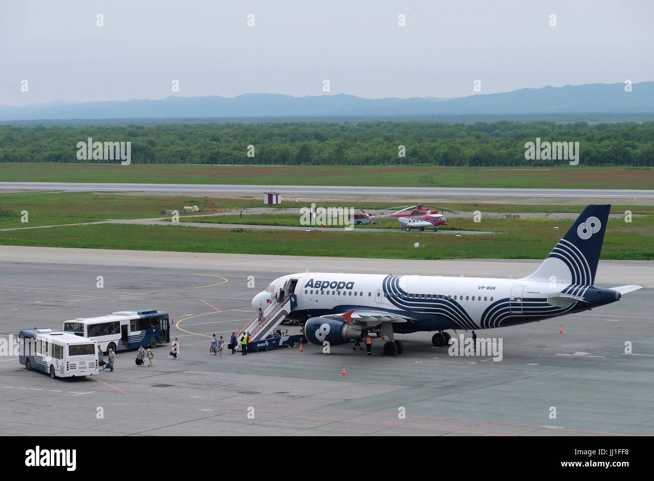 Passengers disembark an Airbus A319 of the Russian Far East air carrier, subsidiary of Aeroflot named after the Russian cruiser Aurora at the runway of Yuzhno-Sakhalinsk Airport also called Khomutovo in the city of Yuzhno-Sakhalinsk, in the island of Sakhalin, in the Pacific Ocean. Russia Stock Photo