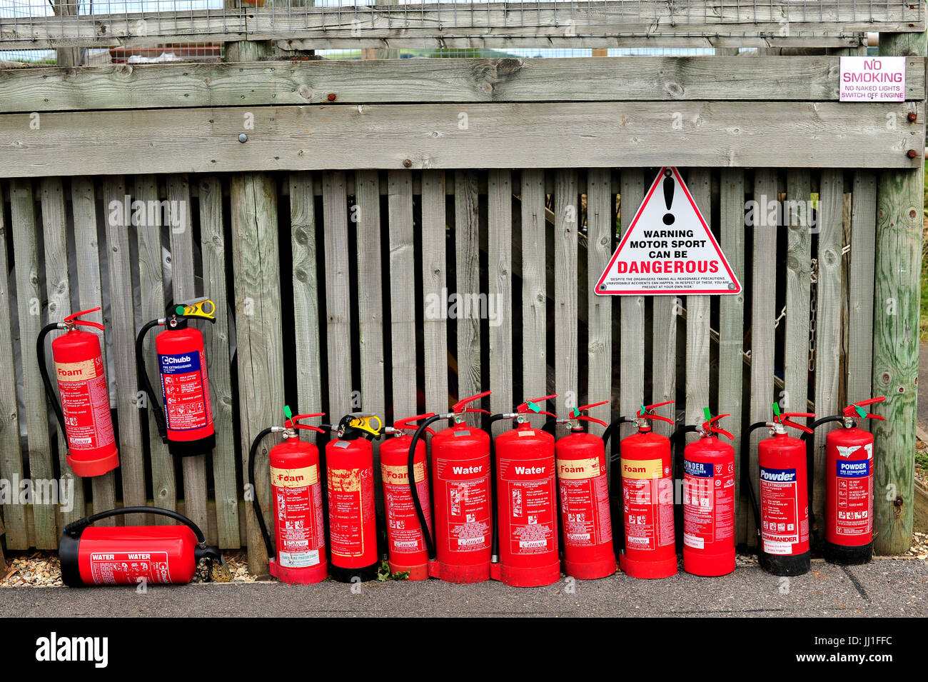 A line of fire extinguishers at the Goodwood racing circuit in West Sussex Stock Photo Alamy