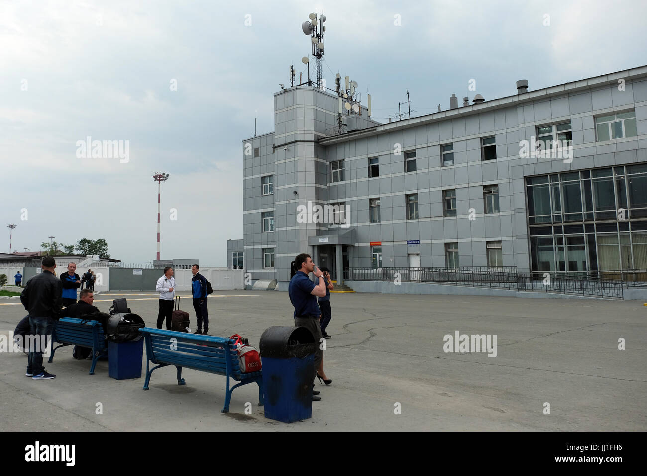 People wait outside Yuzhno-Sakhalinsk Airport also called Khomutovo in the city of Yuzhno-Sakhalinsk, in the island of Sakhalin, in the Pacific Ocean. Russia Stock Photo