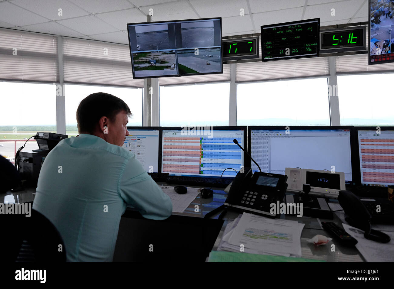 Air traffic controller monitors flights at the control tower of Yuzhno-Sakhalinsk Airport also called Khomutovo in the city of Yuzhno-Sakhalinsk, in the island of Sakhalin, in the Pacific Ocean. Russia Stock Photo
