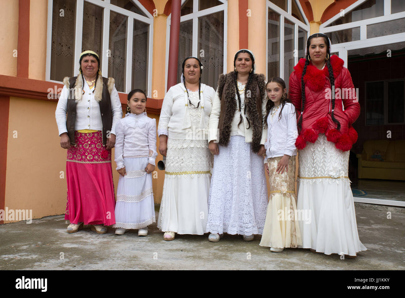 Women and girls of a Rom wealthy family in front of their luxury house, Ivanesti, Romania Stock Photo