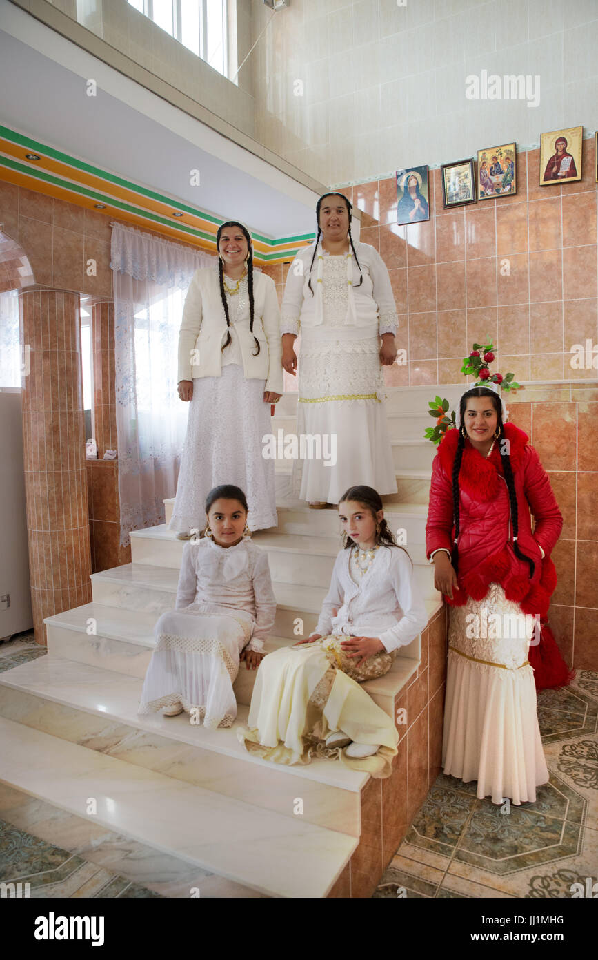 Women and girls of a wealthy Roma gypsy family posing on the staircase of their luxury house, Ivanesti, Romania Stock Photo
