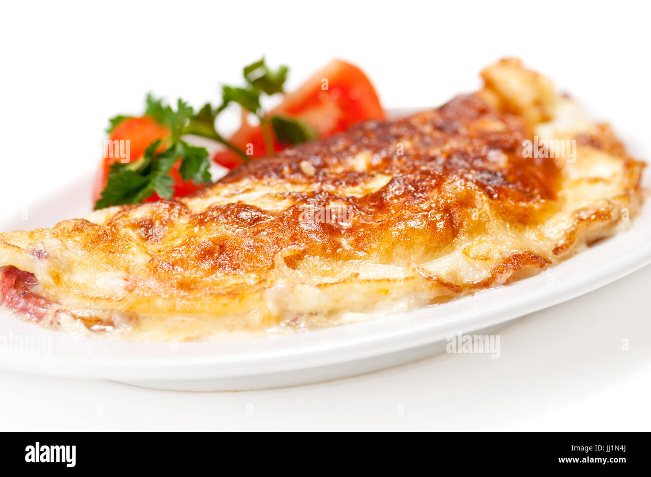 Omelet with herbs and tomatoes Stock Photo