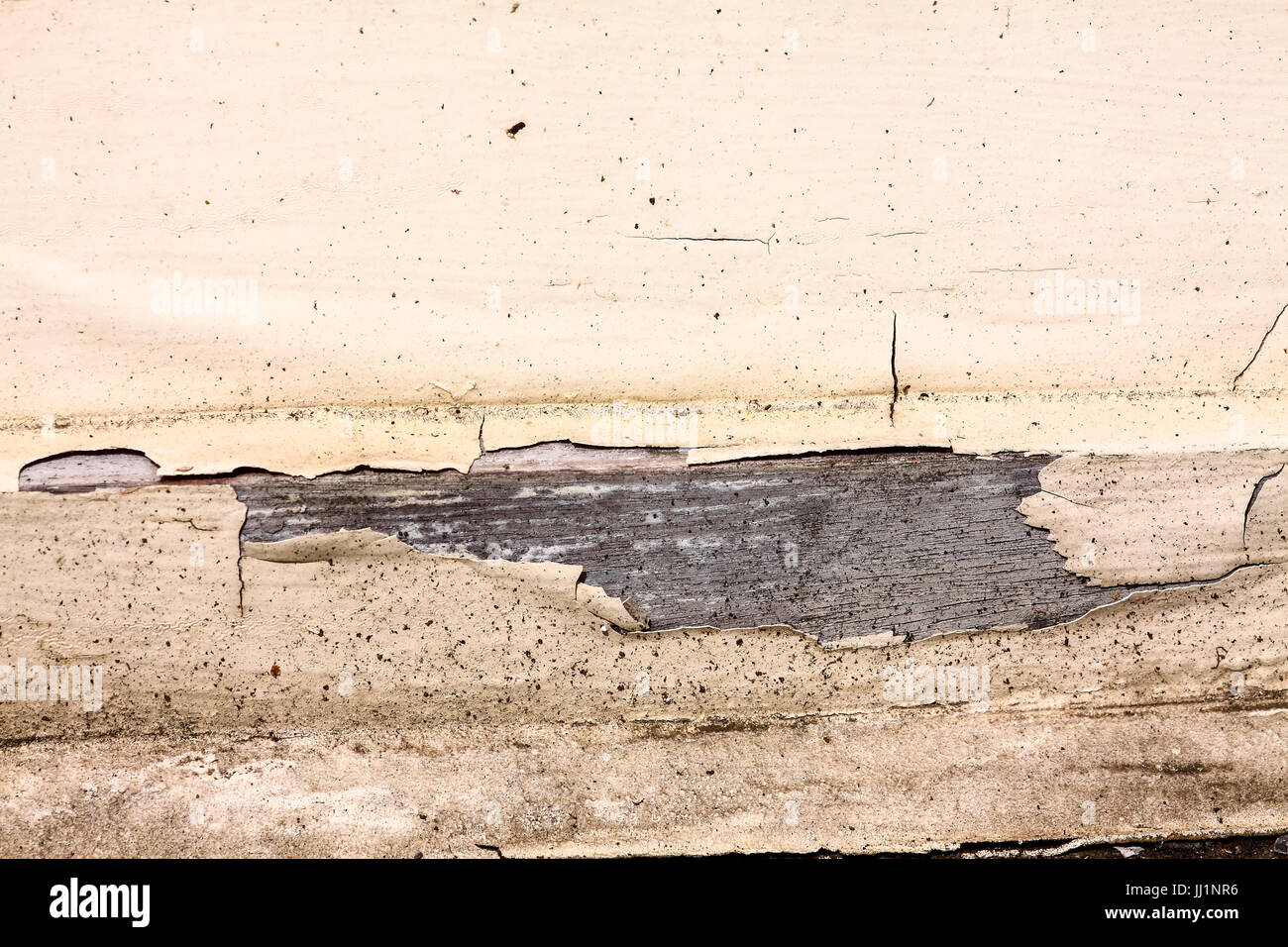 Paint peeling from a wooden window frame in need of repair Stock Photo