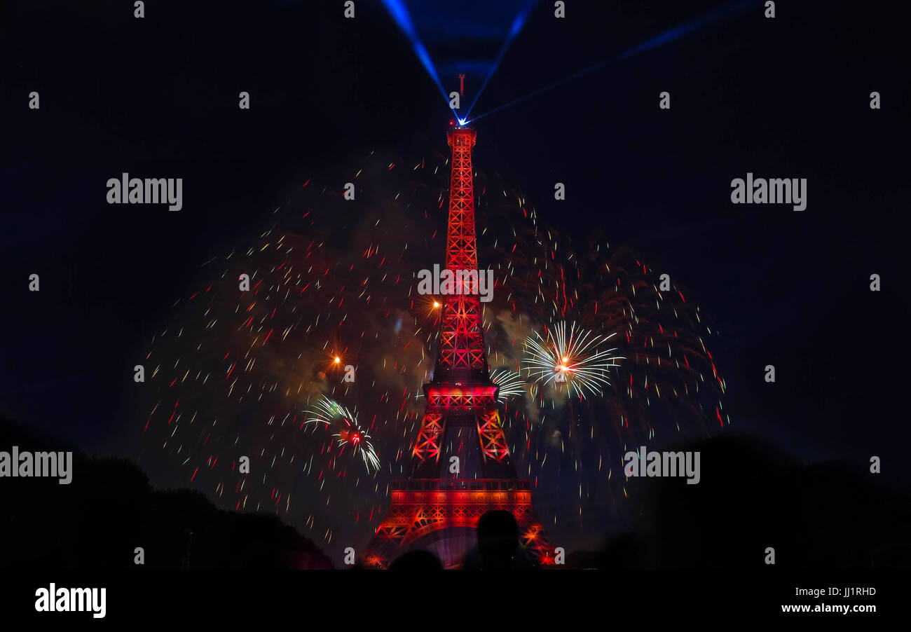 Famous Eiffel Tower and beautiful fireworks during celebrations of French national holiday - Bastille Day. Stock Photo