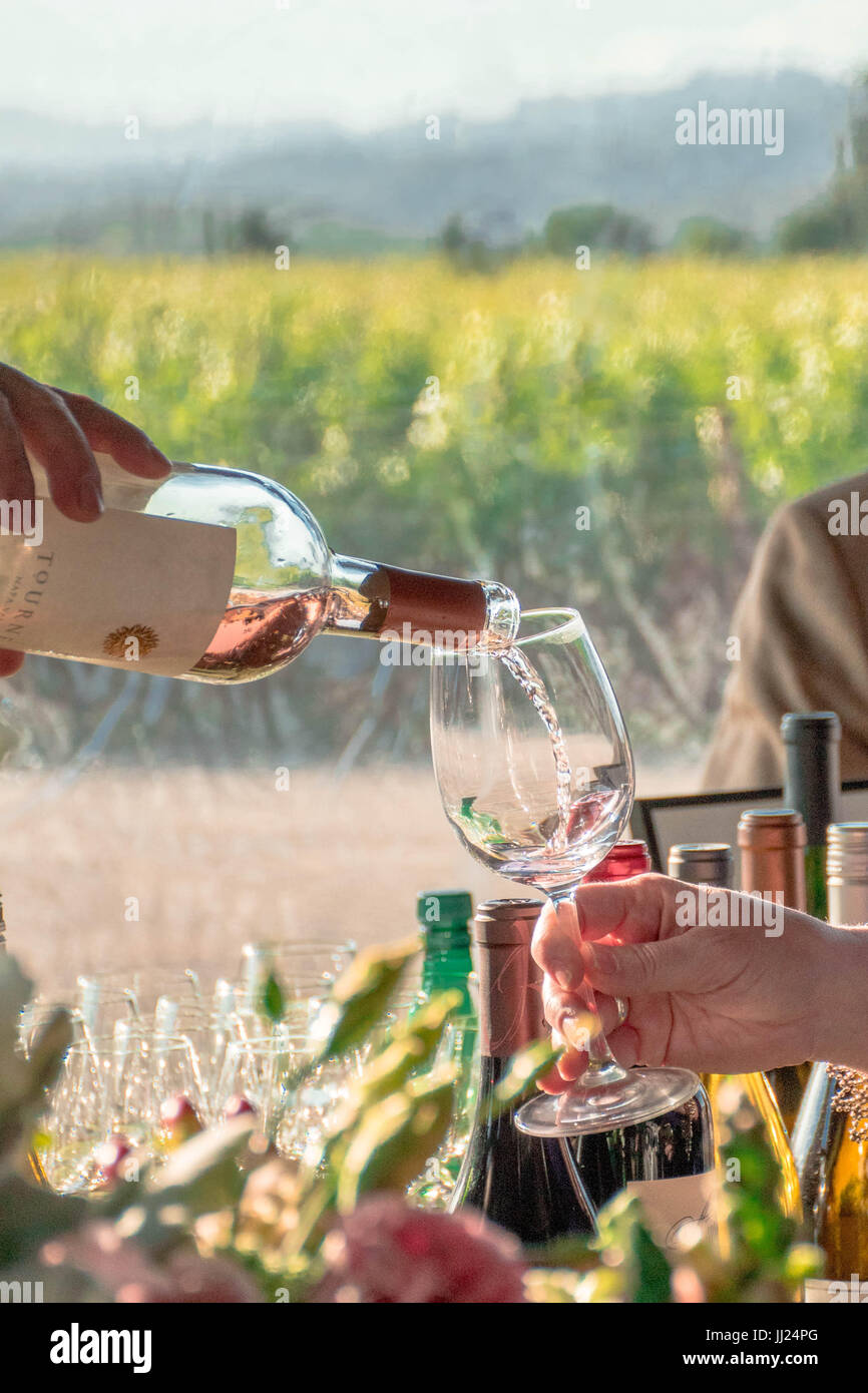 Afternoon Wine Tasting event with wine pouring outdoors in a Napa Valley Vineyard Stock Photo