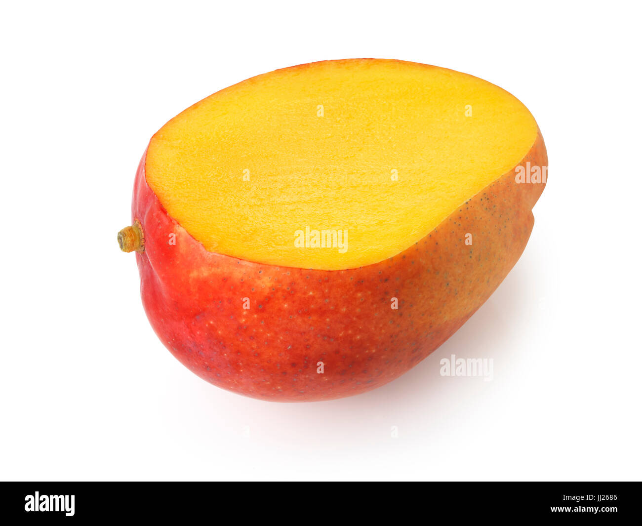 Closeup of a sliced ripe red Kent mango tropical fruit with juicy yellow flesh isolated on white studio background Stock Photo