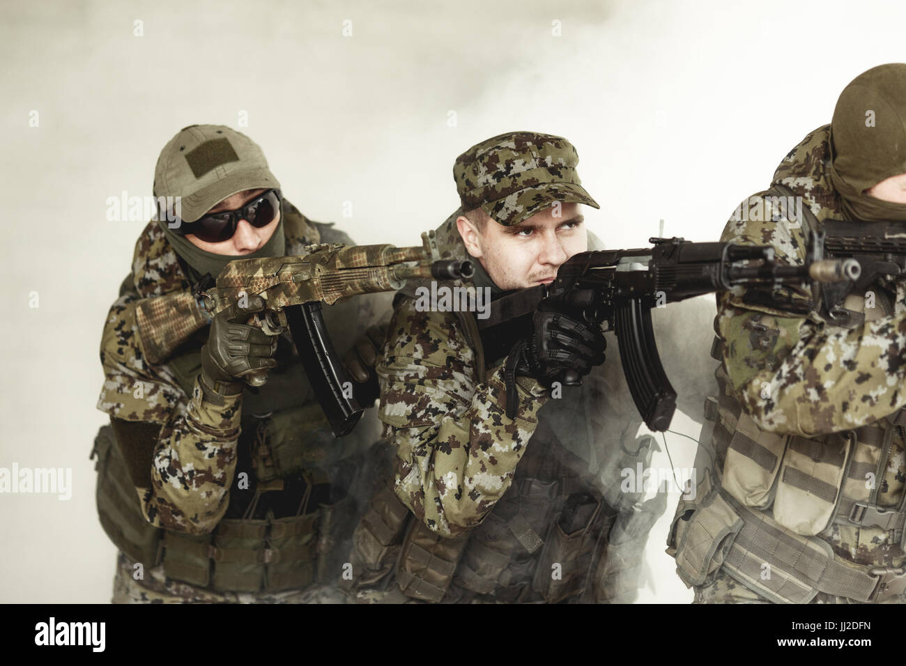 Soldiers in camouflage with weapons Stock Photo