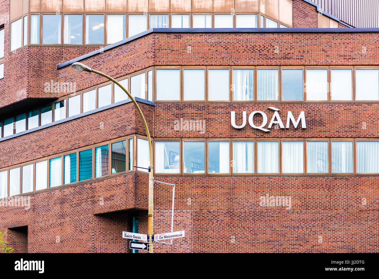 Montreal, Canada - May 26, 2017: UQAM University sign closeup brick building with rue Saint Denis and Boulevard de Maisonneuve Stock Photo