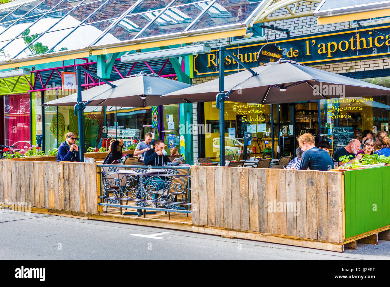 Montreal, Canada - May 27, 2017: St Hubert street covered sidewalk with restaurant in Plateau neighborhood in city in Quebec region Stock Photo