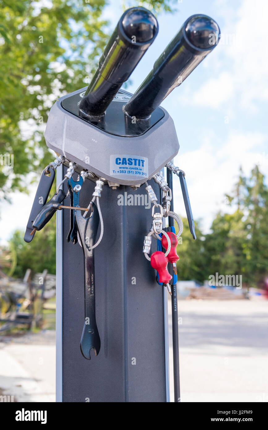 Tools attached by steel cables for repairing bicycles on a bike rack at