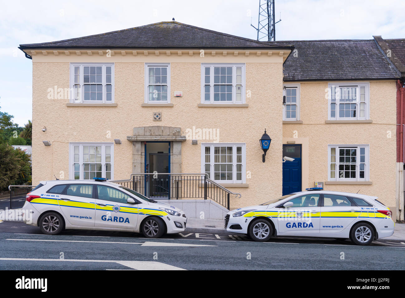 Two liveried patrol cars parked outside a Garda Siochana Irish police station. Stock Photo