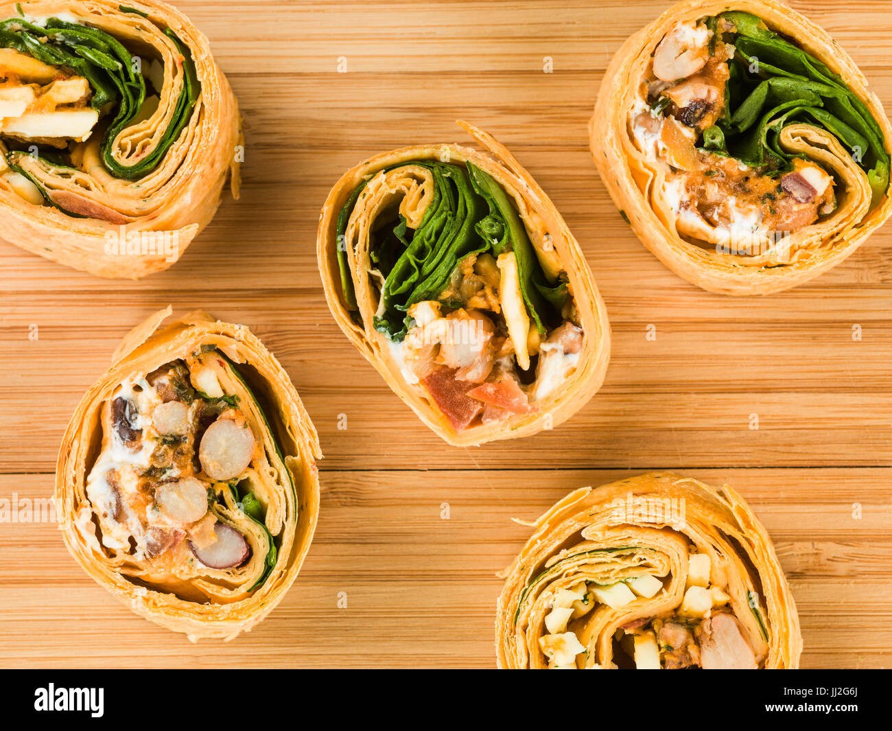 Mexican Style Three Bean Vegetarian Wrap Against a Wooden Kitchen