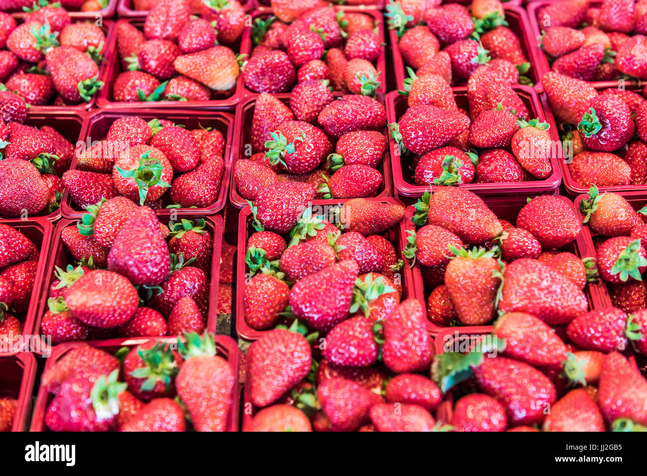Many strawberries on display in market in red baskets Stock Photo Alamy