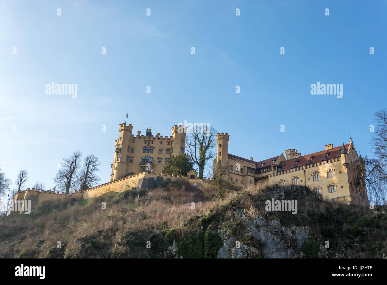 The castle Hohenschwangau on a hill in the sunny afternoon Stock Photo