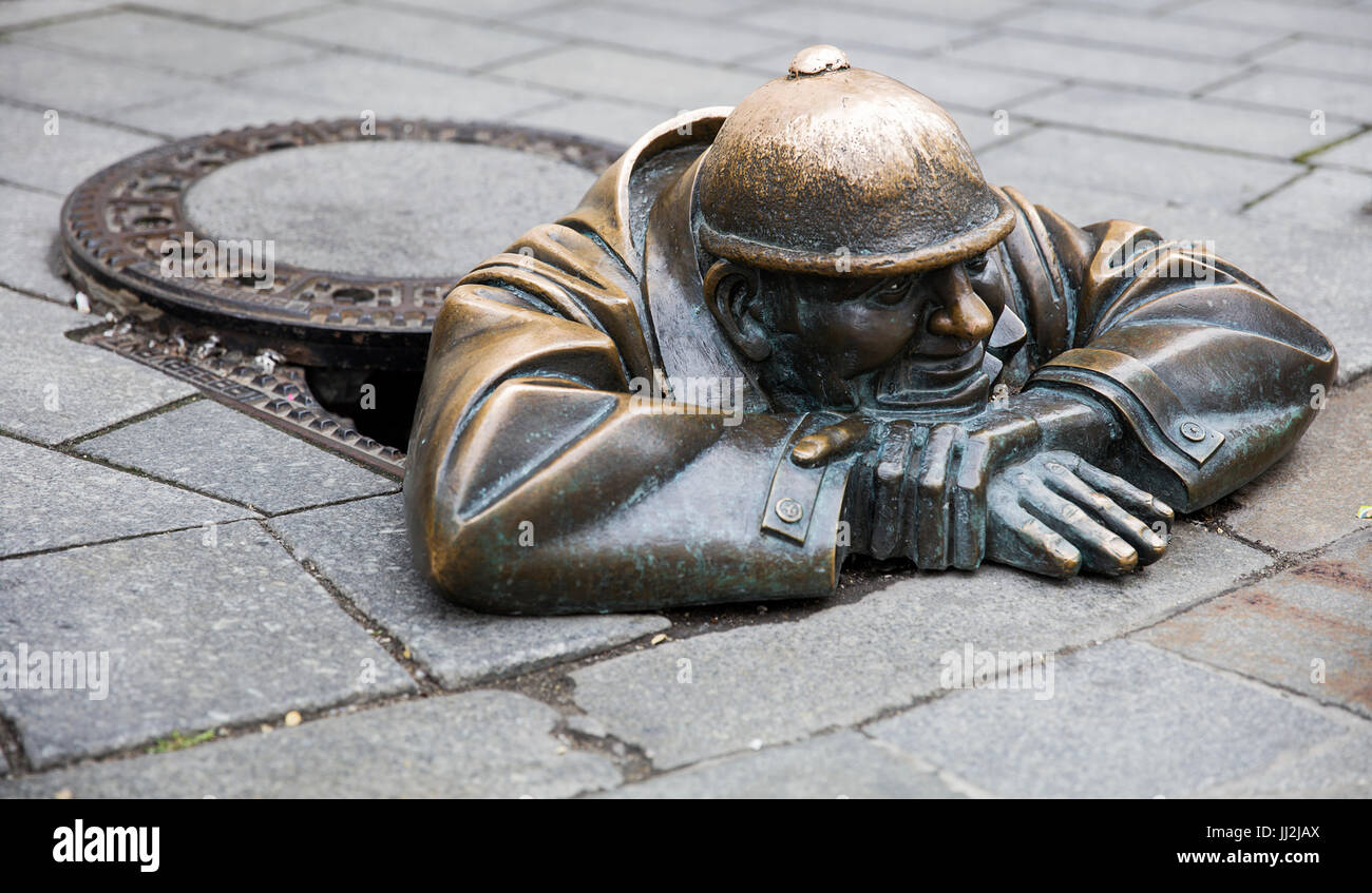 BRATISLAVA, SLOVAKIA - JUNE 16, 2017: Statue Man at work in Bratislava, Slovakia. This bronze statue of sewer worker was created in 1997 by Viktor Hul Stock Photo