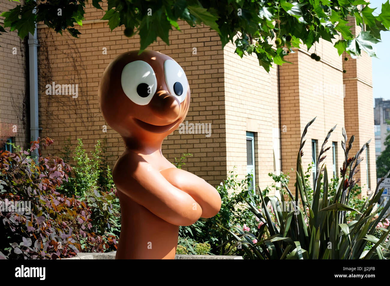 A large, life size sculpture of the Aardman Animation character, Morph, on display on a busy road in the center of Bristol England Stock Photo