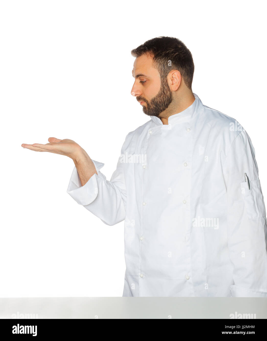 Young chef in white uniform without hat isolated on white background. Stock Photo