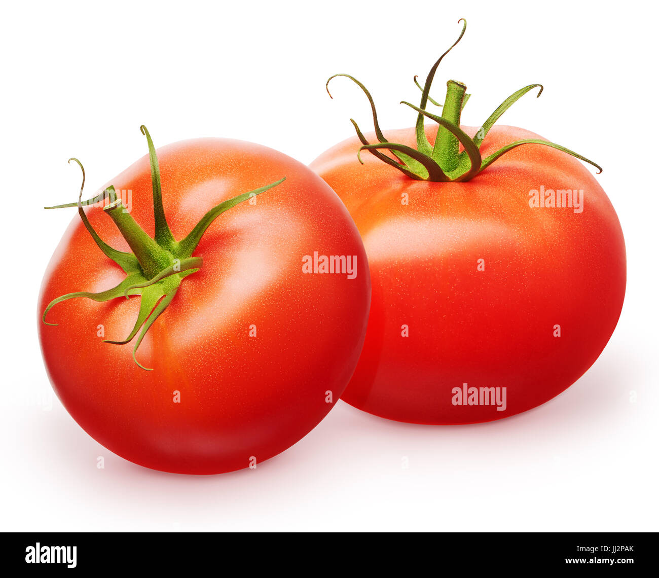 Two whole fresh red tomatoes with green leaves isolated on white ...
