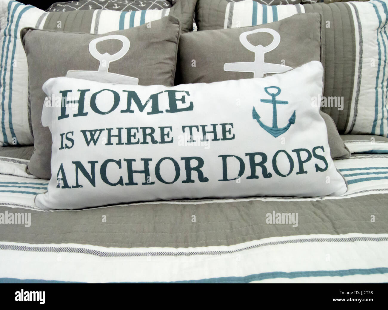 A pillow that reads &lsquo;home is where the anchor drops&rsquo; on a ocean themed