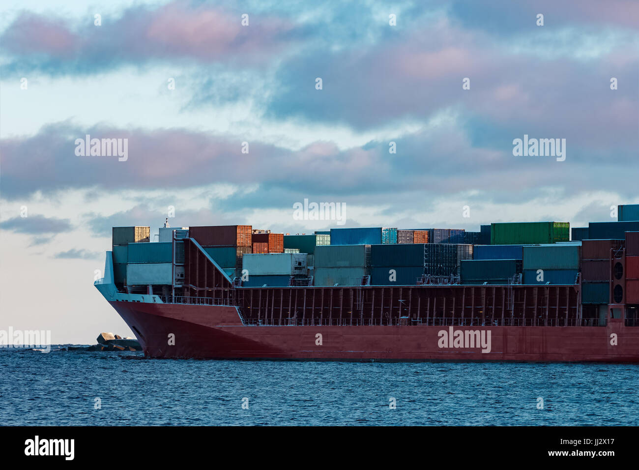 Red Moving Containers Full red container ship moving in still water Stock Photo - Alamy