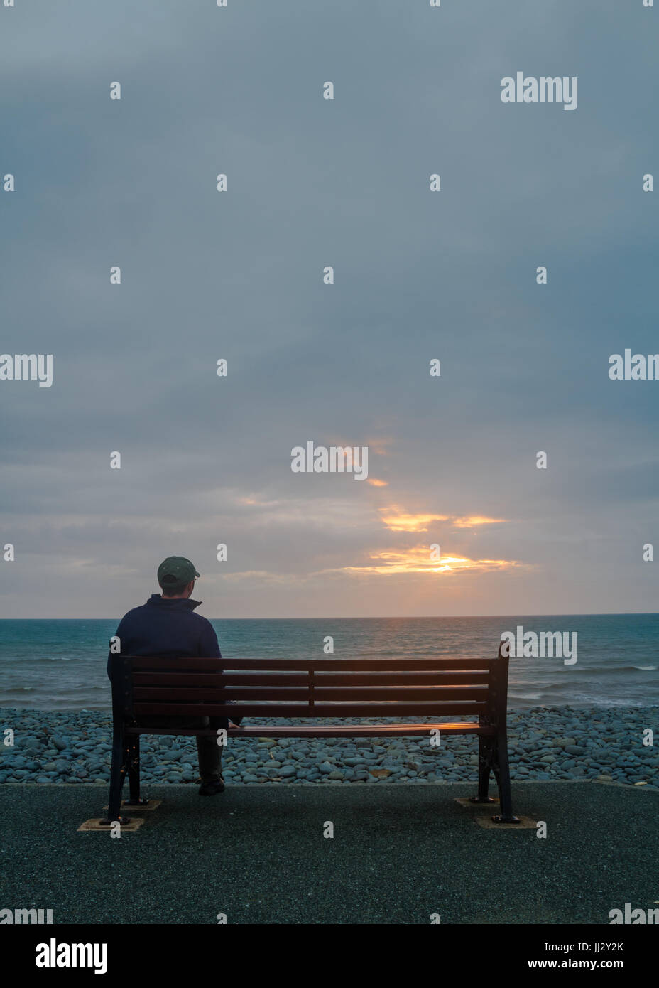 A Seat with a View, Aberaeron Beach at sunset Stock Photo