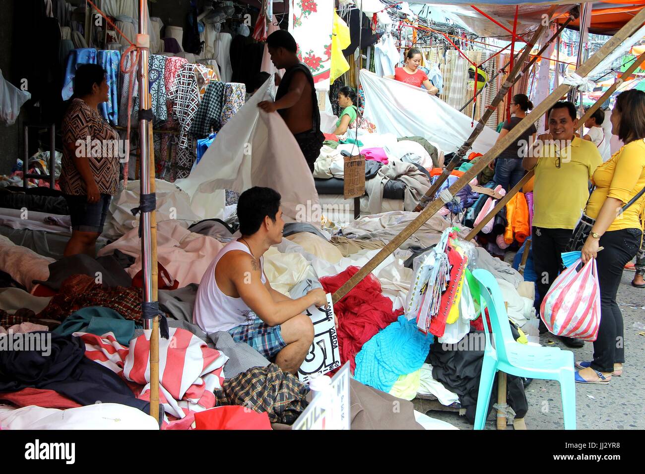 Philippines. 17th July, 2017. A sales person assisted their customer at Divisoria Market in Ylaya Street. Manila City on July 17, 2017. Divisoria Market is the heaven place for all fashion designers where they bought all their materials for making dress at the cheapest price from US$ 0.50 pesos per yard of textiles depends on the kind of textiles. For budget conscious customers they can buy a readymade dress from 500.00 and wedding gowns that stars from US$ 30 per set. Credit: Gregorio B. Dantes Jr./Pacific Press/Alamy Live News Stock Photo