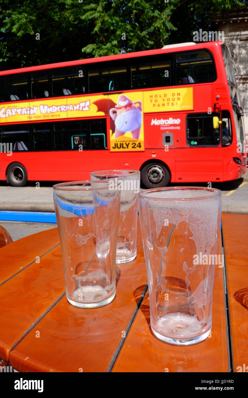 Empty beer glasses on a very sunny and hot summer day at Euston Station, London Stock Photo
