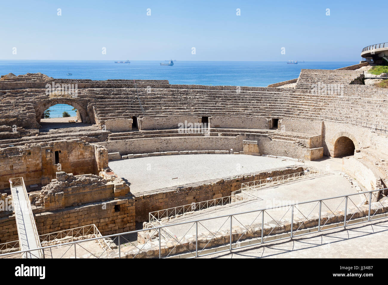 Roman amphitheater in Tarragona city, with the mediterranean sea as background Stock Photo