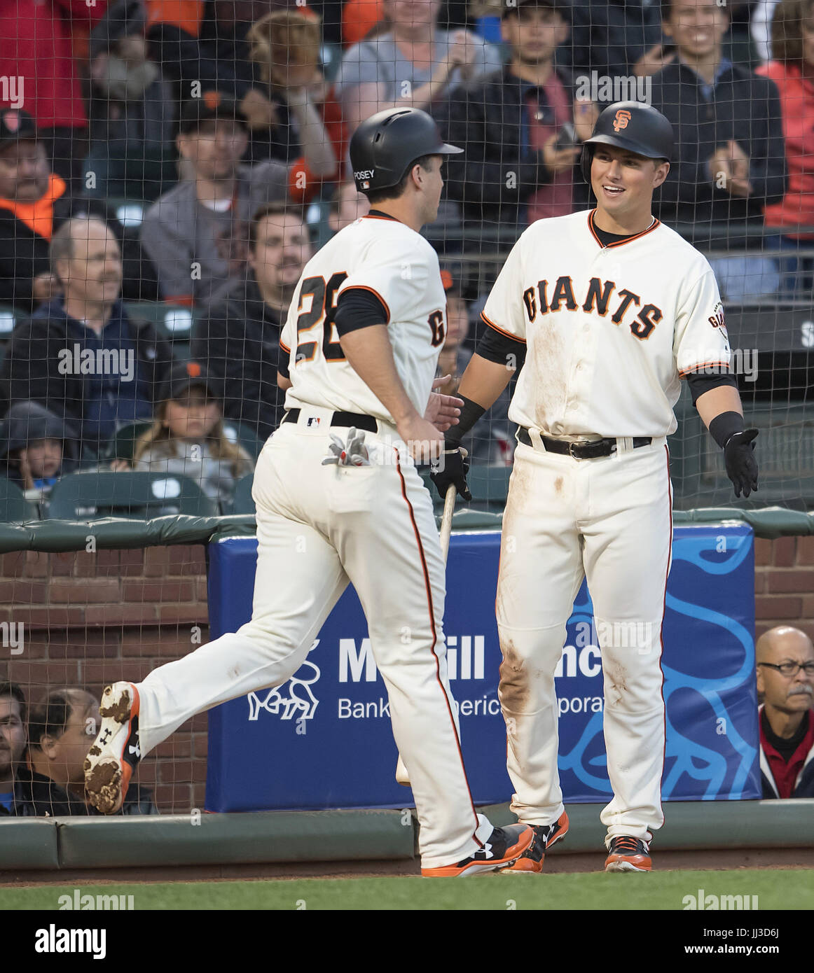 San Francisco, California, USA. 17th July, 2017. San Francisco Giants second baseman Joe Panik (12) congratulates catcher Buster Posey (28) after scoring to make it 3-1 Giants during the fourth inning, of a MLB baseball game between the Cleveland Indians and the San Francisco Giants at AT&T Park in San Francisco, California. The Indians won 5-3. Valerie Shoaps/CSM/Alamy Live News Stock Photo