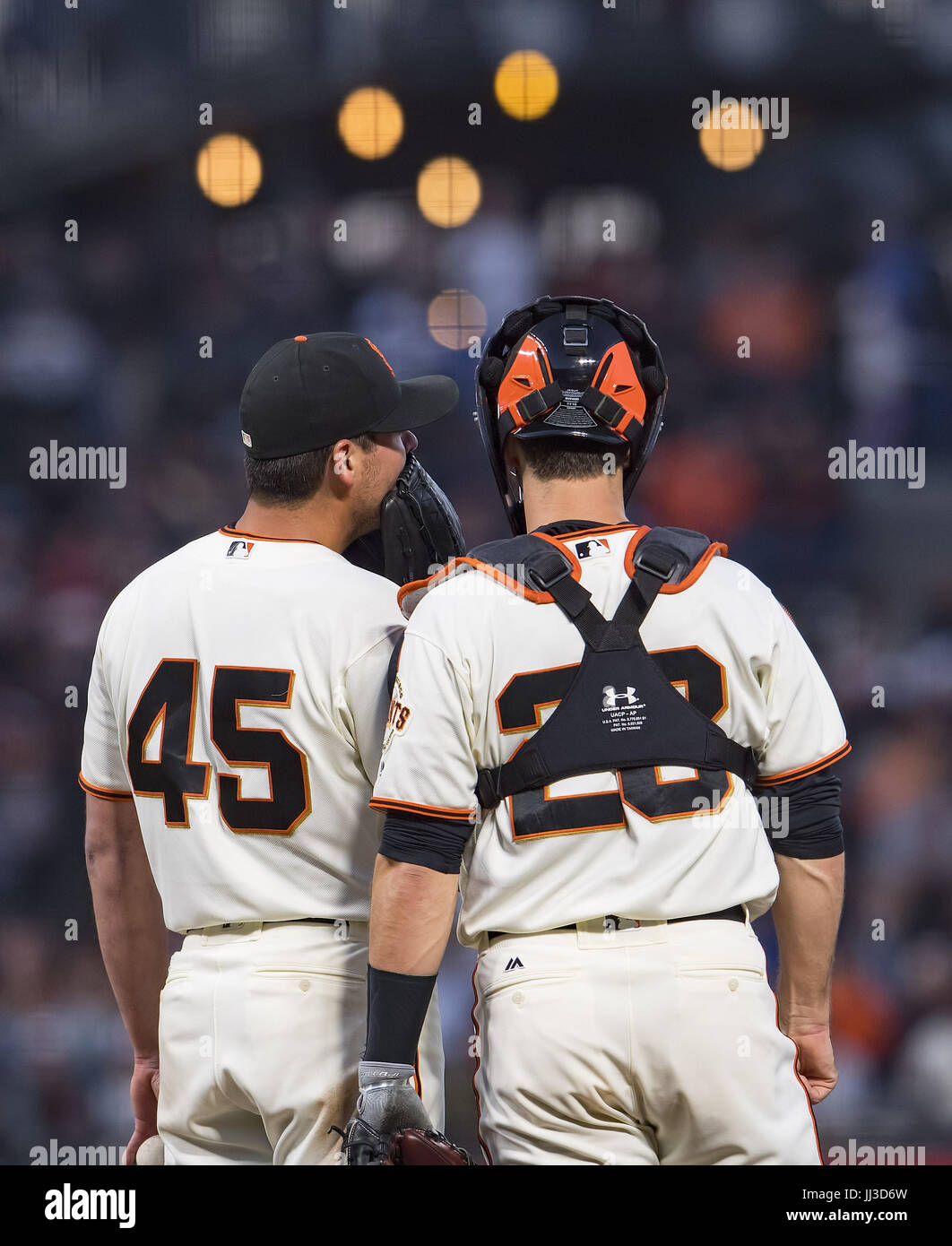 San Francisco, California, USA. 17th July, 2017. With a runner on second base, San Francisco Giants starting pitcher Matt Moore (45) and catcher Buster Posey (28) talk strategy on the mound, during a MLB baseball game between the Cleveland Indians and the San Francisco Giants at AT&T Park in San Francisco, California. Valerie Shoaps/CSM/Alamy Live News Stock Photo